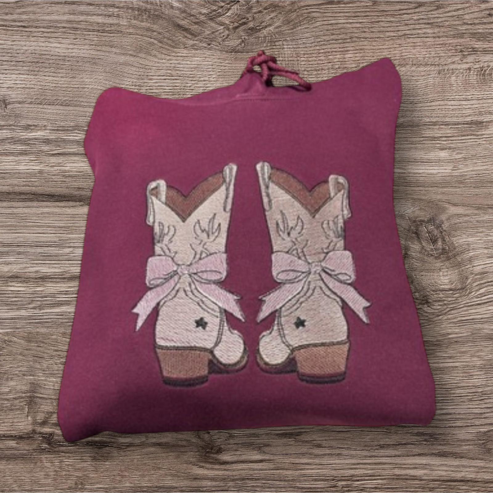 Embroidered cowboy boot with a bow, sweatshirt or hoodie. Country clothing, cowboy hat, western vibes.