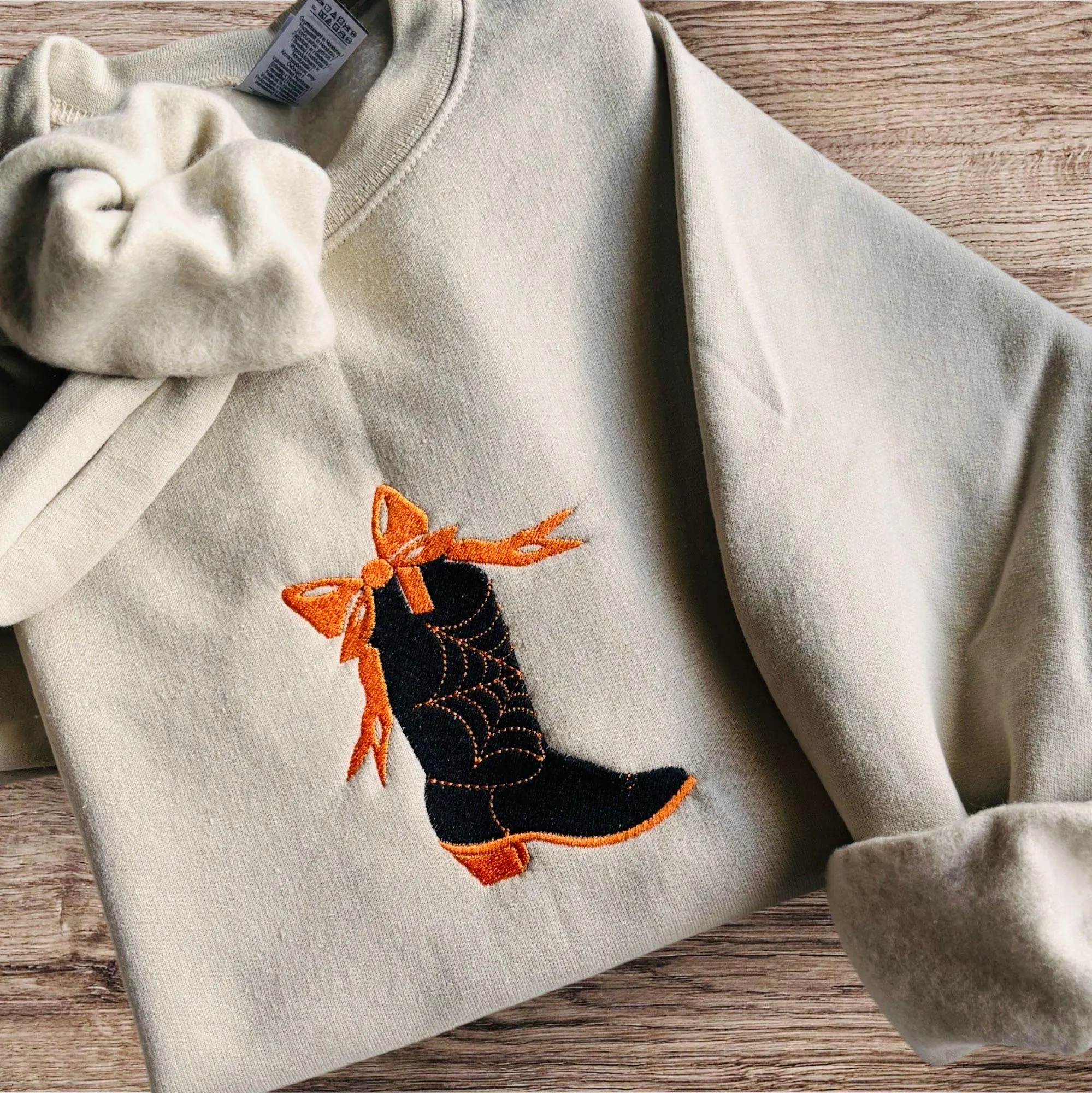 Embroidered spooky cowboy boot with cobweb and bow sweatshirt or hoodie. Western Halloween clothing. - Image 2