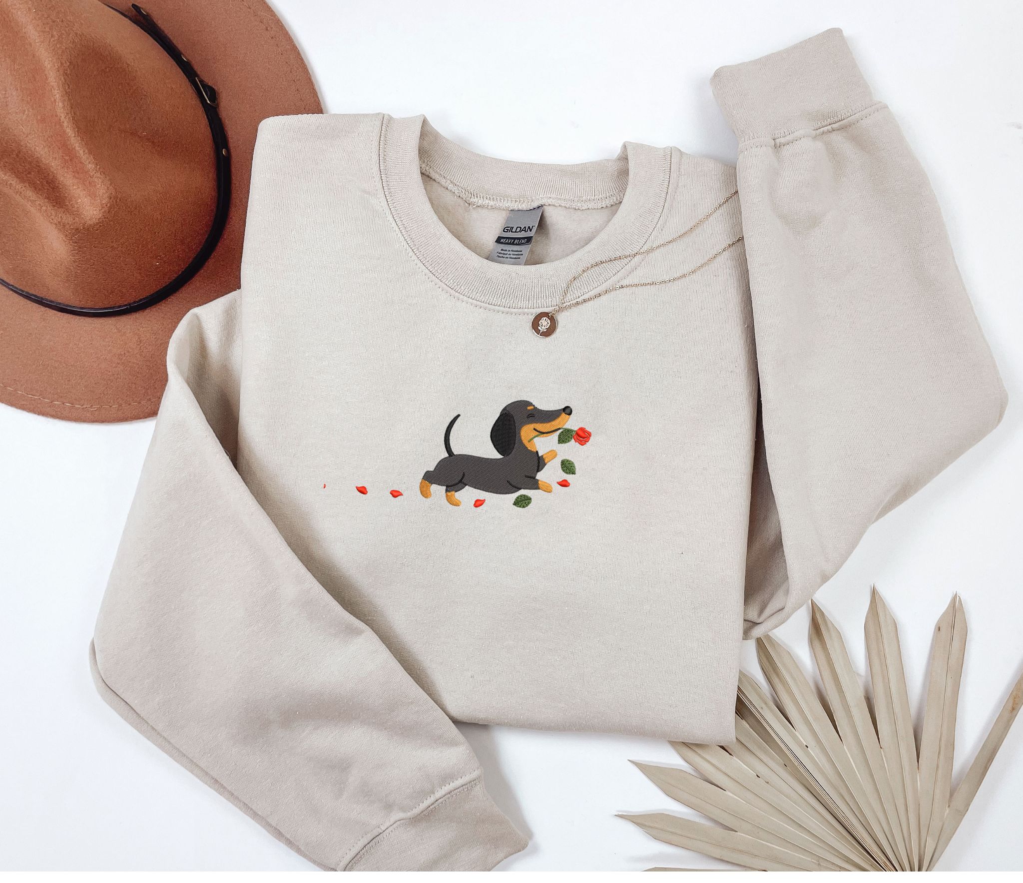 Embroidered Dachshund dog with a rose sweatshirt