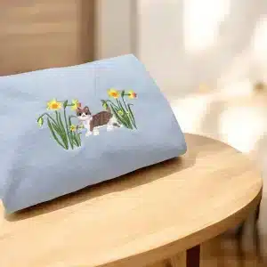 Embroidered cute cat in daffodil flowers sweatshirt.
